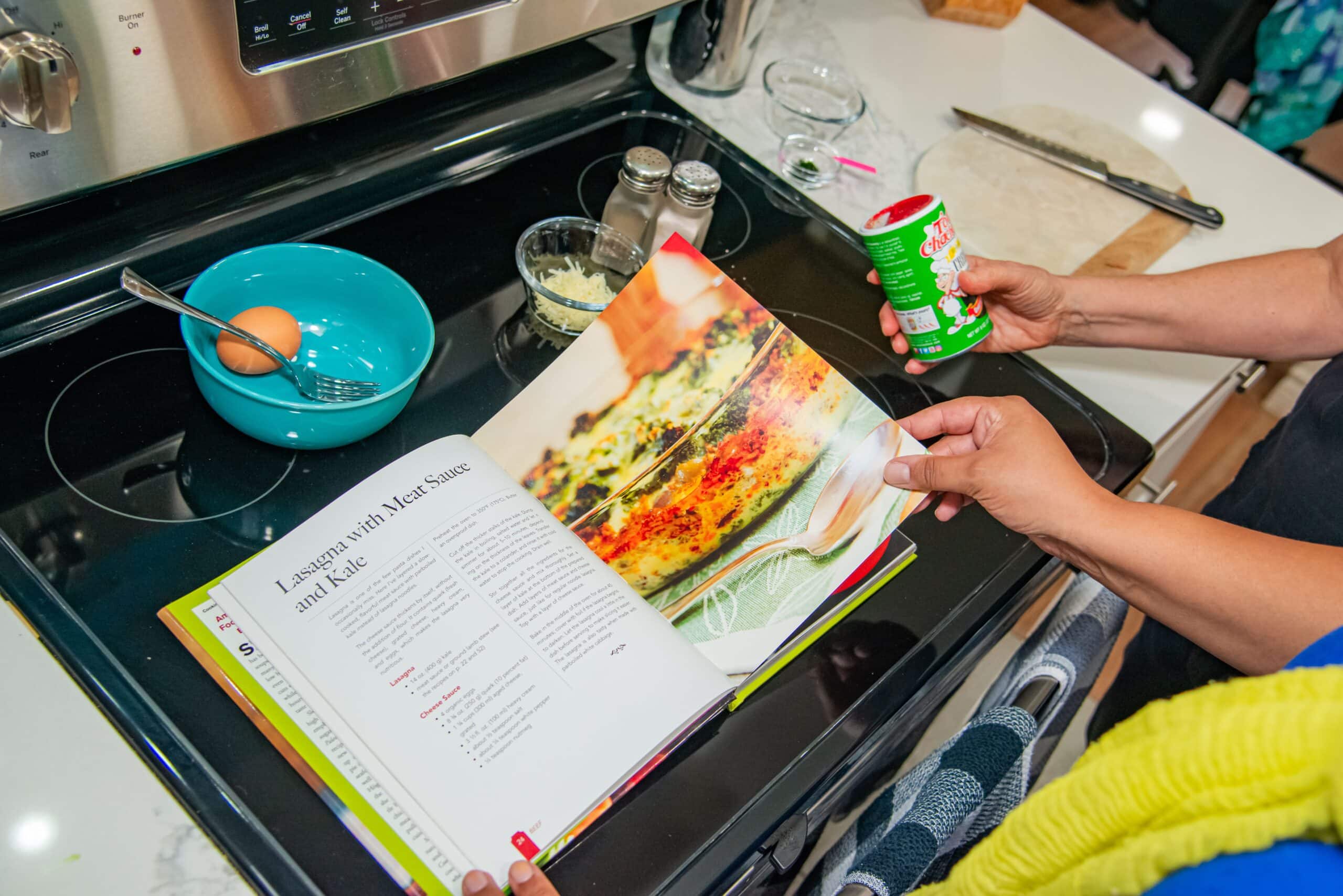 Occupational therapy helps client review recipe for cooking lasagna.