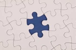 Puzzle pieces with one piece missing symbolize imbalance, problem-solving, and navigating life’s challenges.