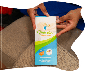 Hands holding Holistic Community Therapy informational brochure