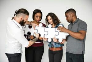 Diverse people puzzle pieces together, holistic community therapy, occupational therapy services Portland, teamwork 