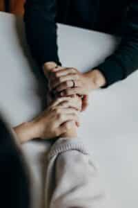 holistic community therapy Portland, two people holding hands together, supportive mental health services, therapist near me