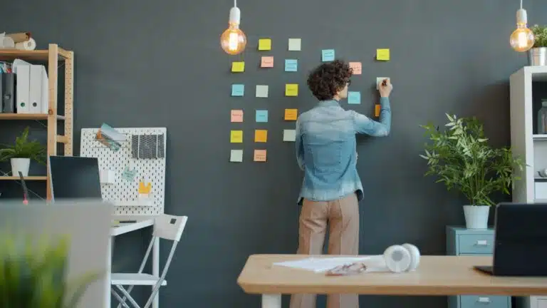 person organizing sticky notes to support a morning routine for attention challenges