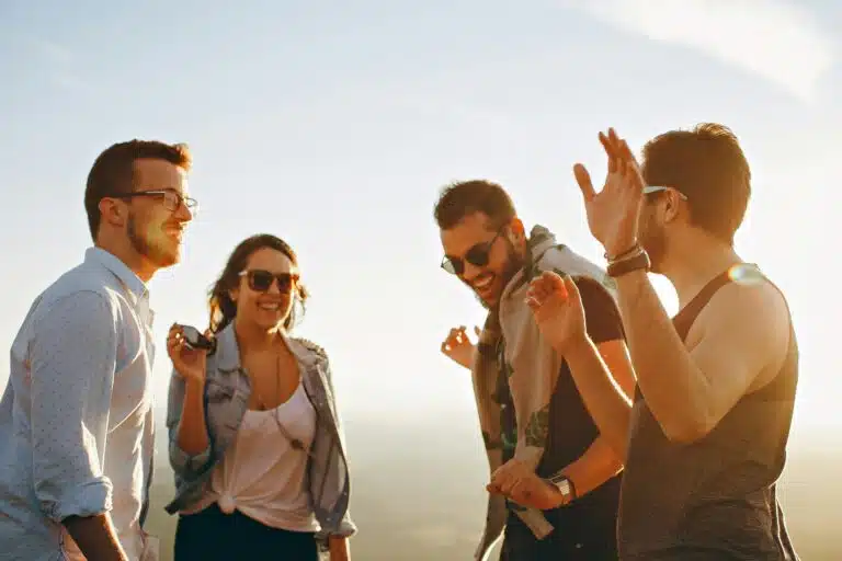 Affirming therapy Portland: A group of LGBTQIA2S+ and poly adults laughing and connecting outdoors
