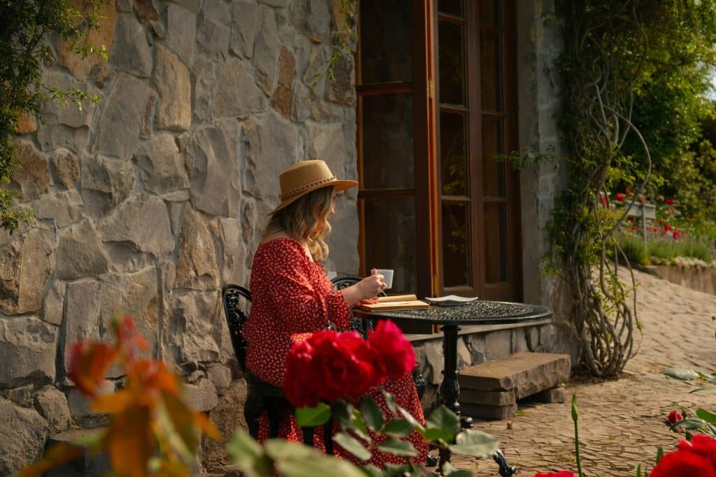 Anxiety routines that support nervous system regulation, shown through a calm morning tea ritual in a quiet outdoor setting.