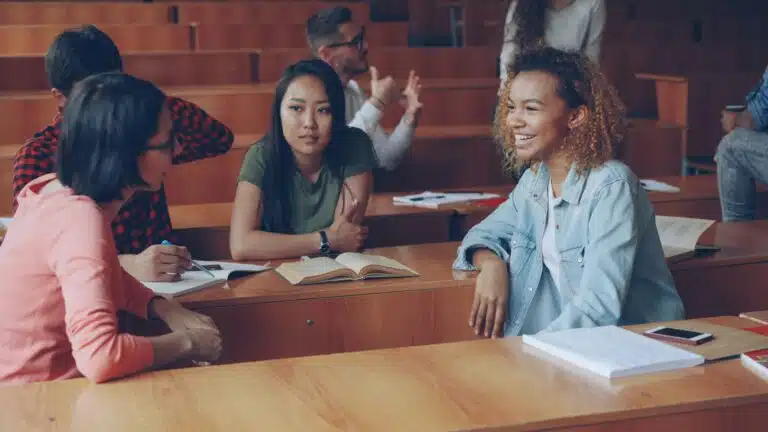 Adults talking together in a supportive group setting, representing therapy for belonging.