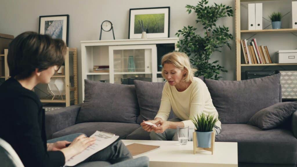 Adult client using sensory tools during an emotional regulation OT session focused on sensory integration therapy in a calm home environment