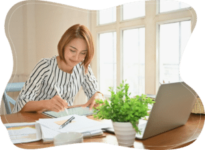 A woman working on a tablet in a professional setting, reflecting focus, productivity, and balancing responsibilities.