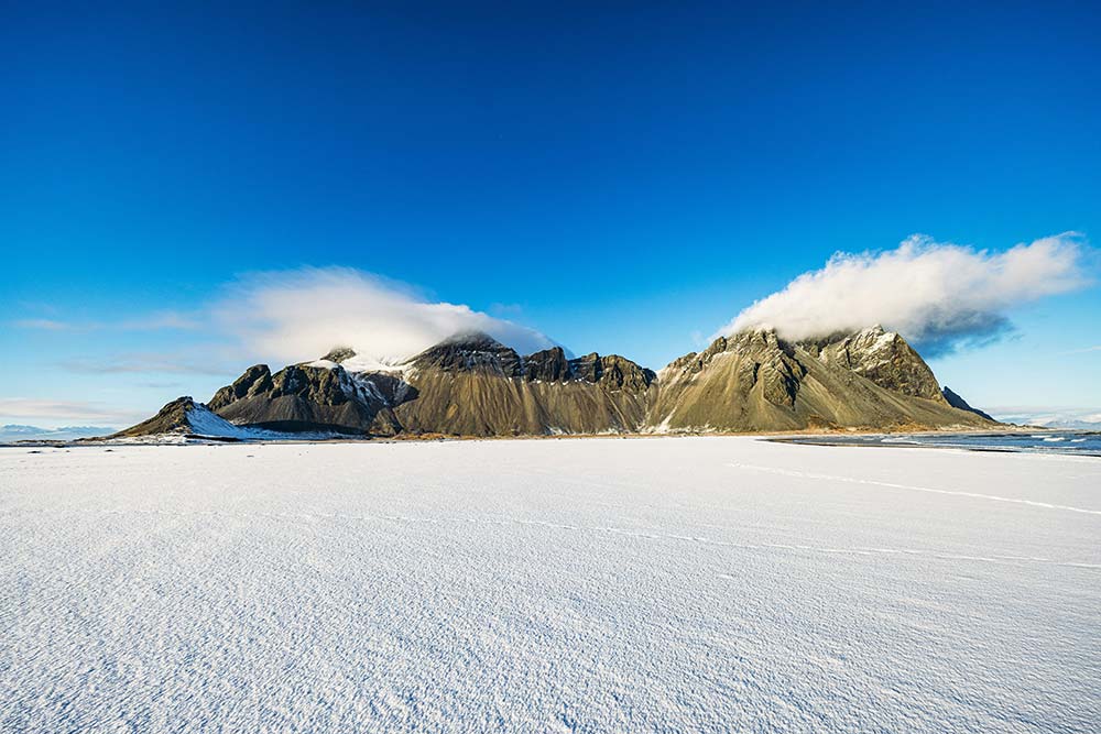 vast snowfield before rugged mountains