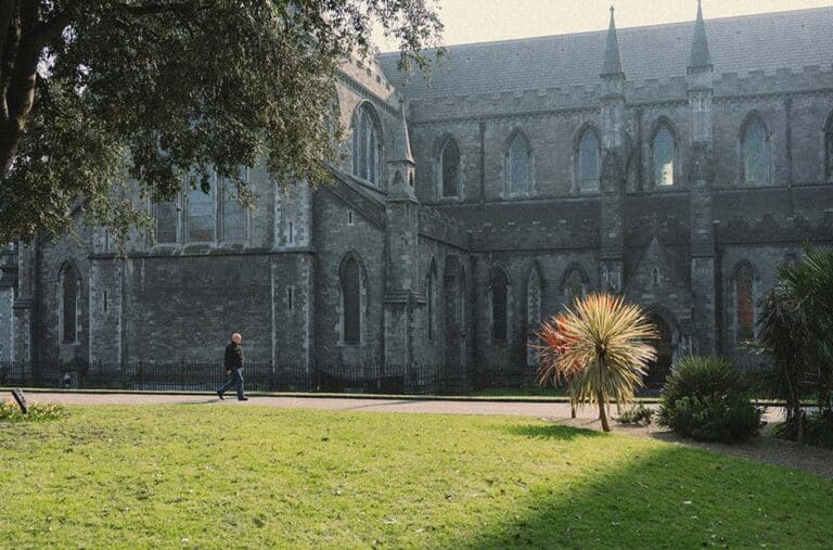 Historic stone cathedral with a green lawn