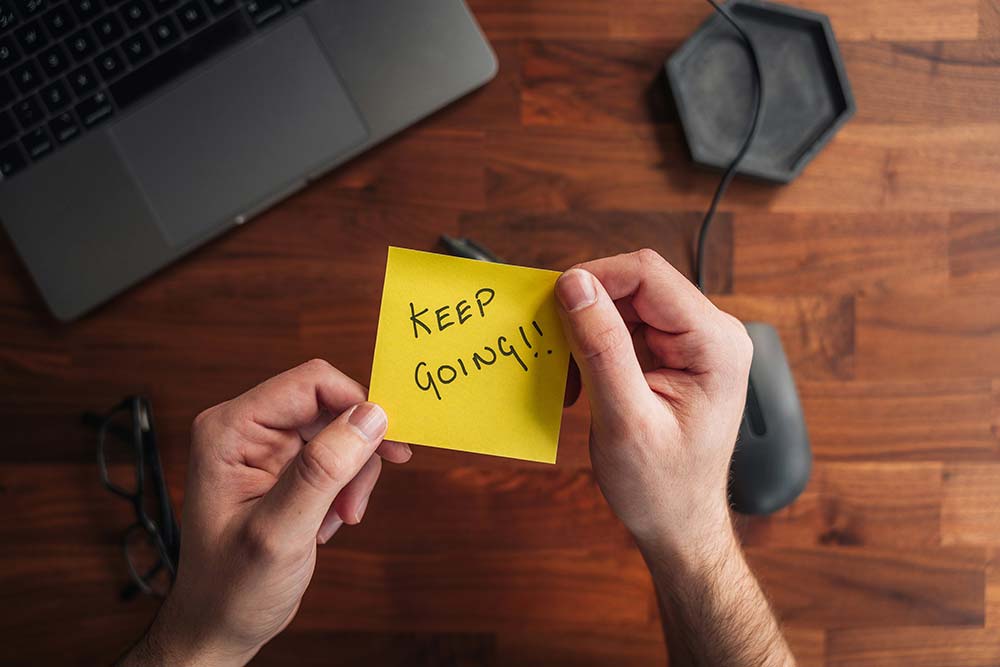 a person holding a sticky note
